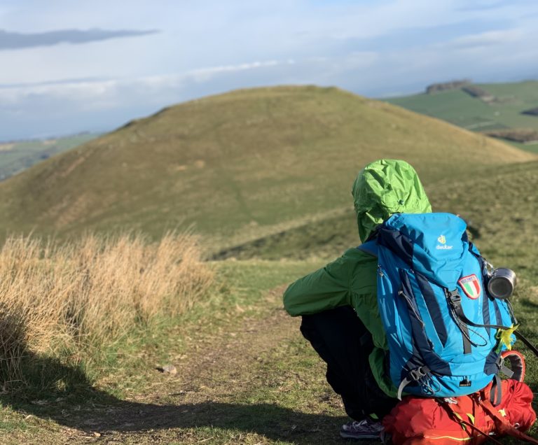 Skyrunning Girl - Sitting down in a field in Scotland